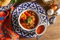 Lagman. Uzbek soup with noodles, lamb, vegetables, herbs and adjika Royalty Free Stock Photo