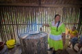 LAGO AGRIO, ECUADOR - NOVEMBER, 17 2016: Woman demonstrates cooking yucca tortillas in an indoors kitchen in a Siona