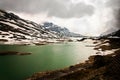 Lago Bianco with green water and snowy mountains Royalty Free Stock Photo