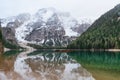 Lago di Braies with boats floating on turquoise water alpine lake in Dolomiti mountains, Belluno, Veneto, Italy with