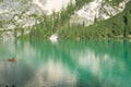 LAGO DI BRAIES, ITALY - SEPTEMBER 6, 2023: Touristic boat on Braies Lake in Dolomites mountains