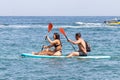 Lagoa, Portugal - July 11, 2020: A couple paddle surfing in benagil caves over turquoise waters