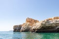 Lagoa, Portugal - July 11, 2020: People fishing from the cliffs of the Lagoa region. Coastline formed of towering cliffs,