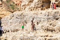 Lagoa, Portugal - July 11, 2020: View from the sea of people in the cliffs of the Lagoa region. Has a coastline formed of towering