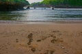 Lagoon bay surrounded from green rock hills. Foot prints in sand beach Royalty Free Stock Photo