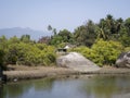 Lagoon with a huge stones near the village in the jungles of India