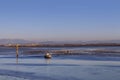 Lagoon of Marano Lagunare with fisherman boat at sunset. Royalty Free Stock Photo