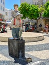 LAGOS, PORTUGAL - AUGUST 03, 2017: Live statue of a man giving a presentation on the street