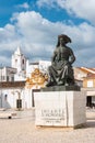 LAGOS, PORTUGAL - CIRCA APRIL 2018: Statue of Infante Dom Henrique (Prince Henry) in the town square with town buildings to the r Royalty Free Stock Photo