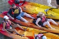 Group of tourists exercising on yellow kayaks