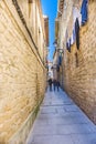 Laguardia, Alava, Spain. March 30, 2018: Young people strolling down a narrow street in the center of the village with floors of l