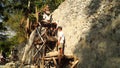 A team of men gather stones to build rip rapped structure.