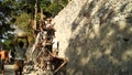 A team of men gather stones to build rip rapped structure.