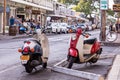 Two Honda Metropolitan II scooters parked on a busy tourists street in a city