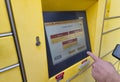 Lahde, Germany - April 15 2025: User interacting with a digital screen of a DHL package locker, selecting package size o Royalty Free Stock Photo