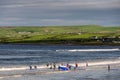 Lahinch / Ireland 08/06/2020: Beach full of surfers of all age on a warm sunny day. Cloudy sky