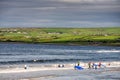 Lahinch / Ireland 08/06/2020: Beach full of surfers of all age on a warm sunny day. Cloudy sky