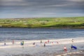 Lahinch / Ireland 08/06/2020: Beach full of surfers of all age on a warm sunny day. Cloudy sky