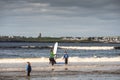 Lahinch / Ireland 08/06/2020: Beach full of surfers of all age on a warm sunny day. Cloudy sky