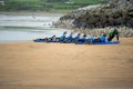 Lahinch / Ireland 08/06/2020: Couch teaches a group young boys surfing on a beach, kids dressed in wet suits Royalty Free Stock Photo