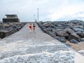 Lahinch, Ireland -01.14.2023: Two beautiful women walking from the beach after swimming in cold winter water