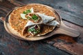 Lahmacun traditional Turkish pizza and wraps with salad on rustic wooden table