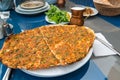 Lahmacun Turkish pizza on the table with ayran