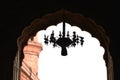silhouette view of ceiling fanos lamp inside the badshahi mosque