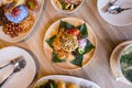 Lahpet is Burmese Tea Leaf Salad served with deep fried garlic, peanut, white sesame, dried shrimp, ginger and roasted coconut