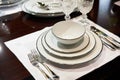 Table served with expensive white dishes and crystal glasses