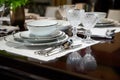 Laid dining table served with expensive white dishes