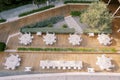 Laid festive round and long tables stand on a wooden deck in the garden. Top view