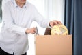 The laid-off employee packs up personal belongings