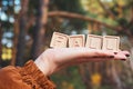 The laid out inscription fall. A word made of cubes on a woman& x27;s hand. Autumn forest Royalty Free Stock Photo