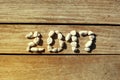 2017 laid out stones on a background wooden pier.