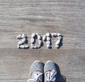 2017 laid out stones on a background wooden pier.