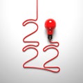 `2022` laid out of a wire and a light bulb on a white background. Royalty Free Stock Photo