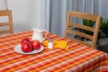 Laid table - fork and spoon laid on yellow, red and orange cloth