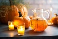 Laid table served with orange drinks is traditionally decorated with cut out jack-o\'-lanterns and lights for Halloween