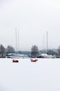 Laid up sailboats in ice covered harbor at the Baltic Sea for winter lay-up concept Royalty Free Stock Photo