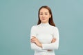 Laighing woman with crossed arms looking at the camera over white background