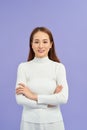 Laighing woman with crossed arms looking at the camera over white background