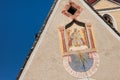 LAION, ITALY - SEPTEMBER 02, 2020: The recently restored clock and sundial painted outside the bell tower of the church of the