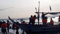 Unrecognizable young active people enjoy swimming in the shallow waters of the sea during the hot summer. Silhouettes, blurs