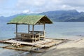 Floating beach bamboo and palm cottage parasol on white sand coast