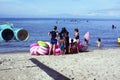 Young man sells and peddles ring lifebuoy on white sand beach