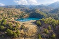 Lake in abandoned mine pit and waste heaps over mountains landscape in Xyliatos, Cyprus Royalty Free Stock Photo