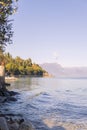 Lake in the alps and a beautiful beach with trees. Travel and tourism in Europe. Free space for text Royalty Free Stock Photo