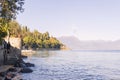 Lake in the alps and a beautiful beach with trees. Travel and tourism in Europe. Free space for text Royalty Free Stock Photo