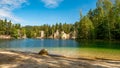 Lake and ancient pines growing between them located in rock city Adrspach, National park of Adrspach, Czech Republic